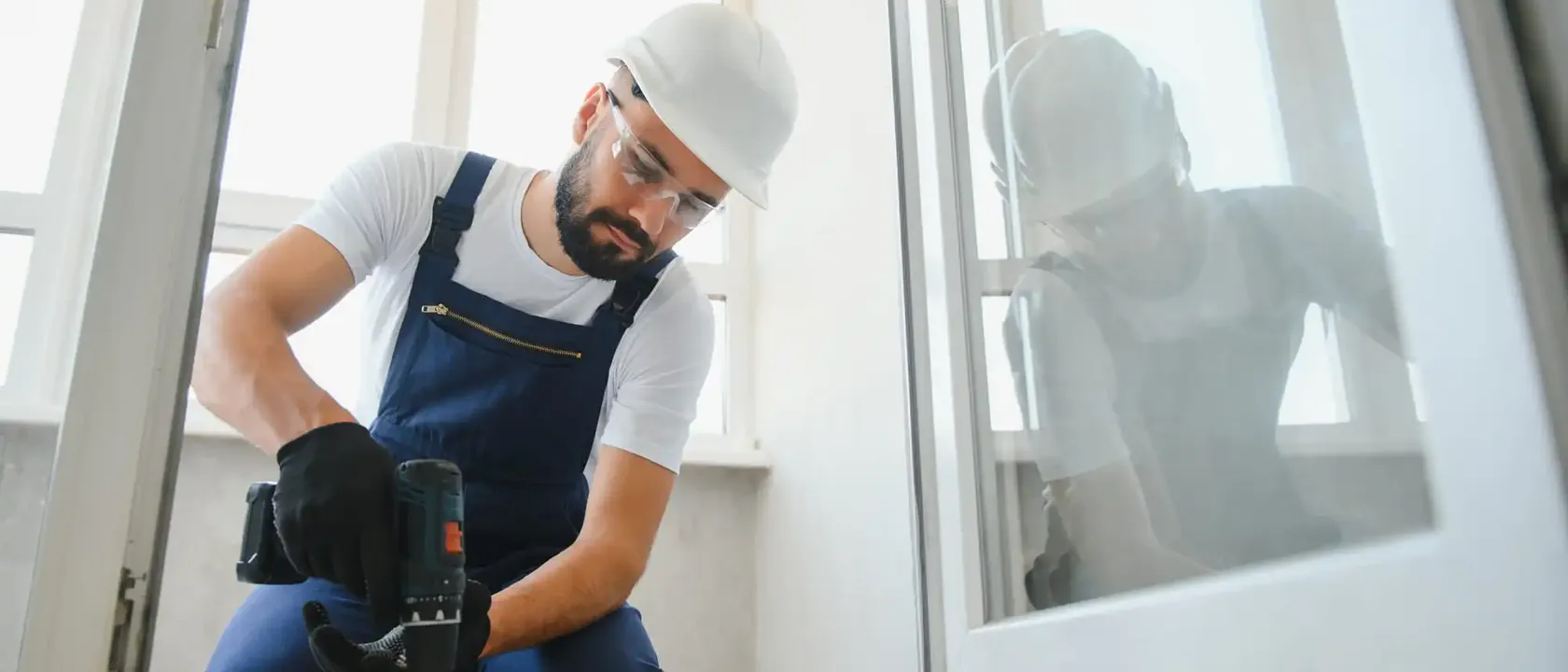 Technician working on the glazed frame of a commercial door opening